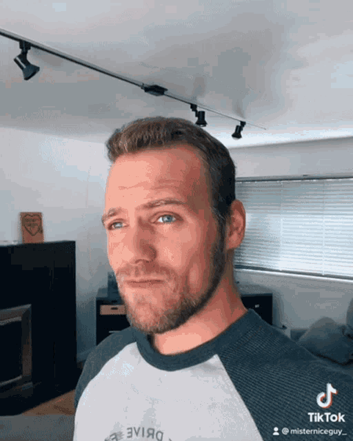 a man with a beard wearing a tiktok shirt